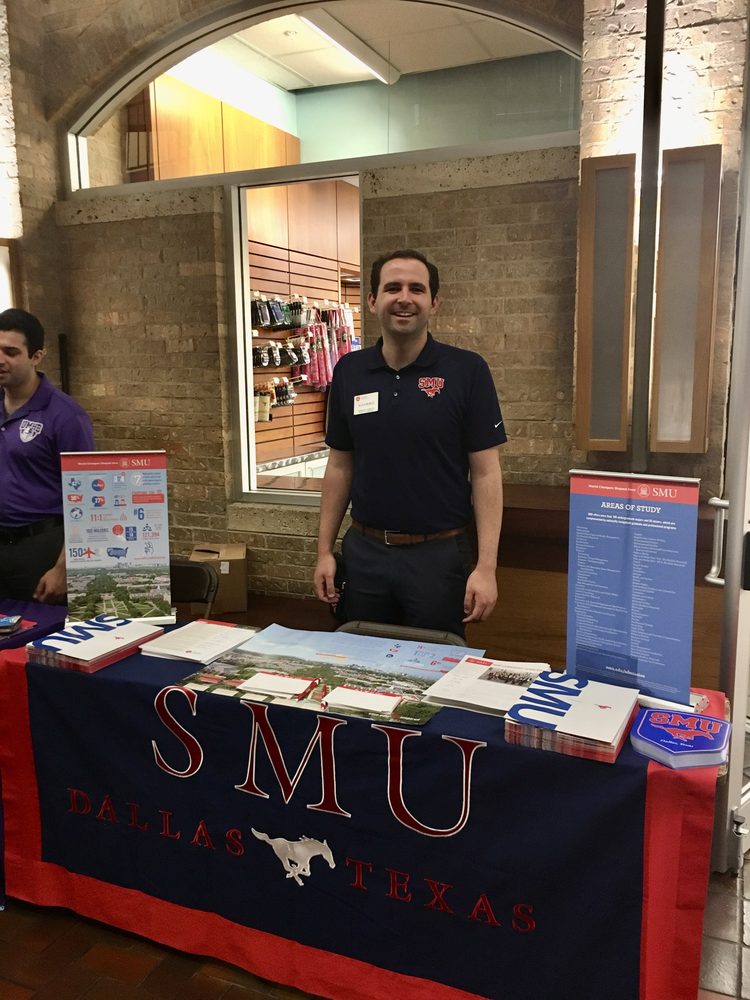 Alex Munoz at an SMU admissions table during college fair season