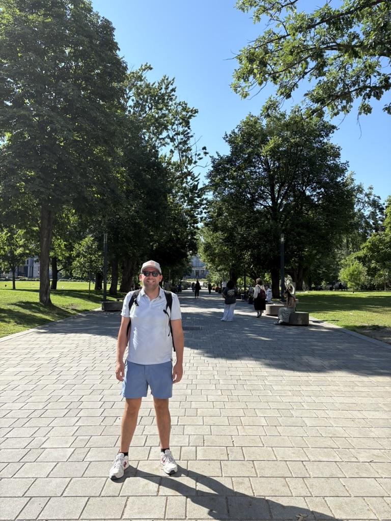 Alex Munoz standing on the tree-lined path of McGill University's downtown Montreal campus