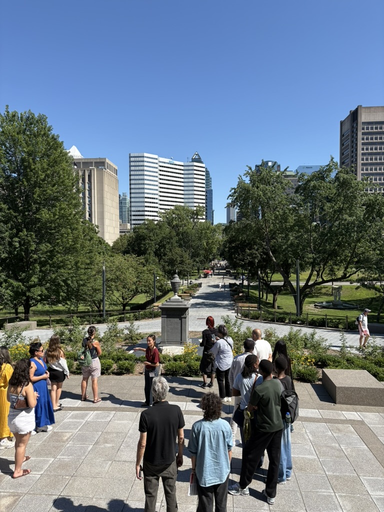 A prospective student tour group overlooking downtown Montreal from McGill University's upper campus