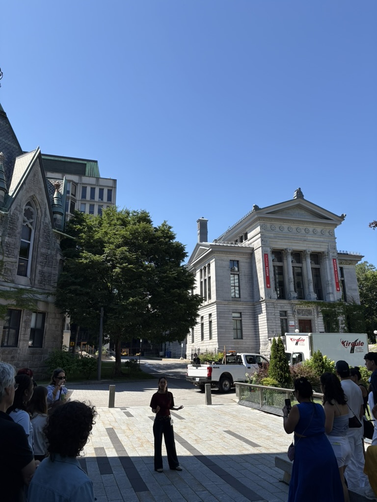 Redpath Museum on McGill University's campus with a tour guide addressing a group of prospective students